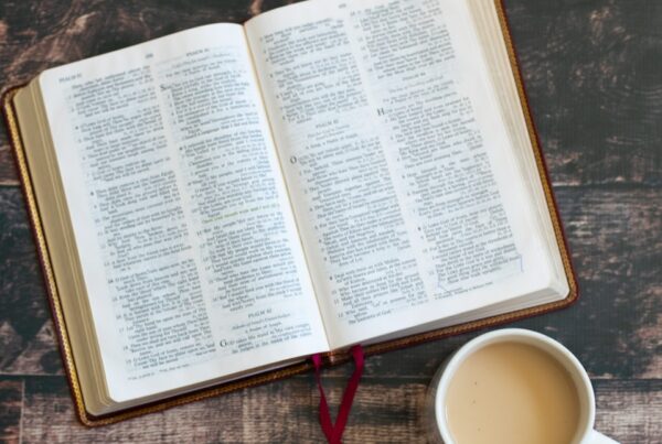 white book page beside white ceramic mug
